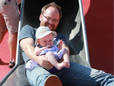 Stephen Bodrug and Willow Bodrug fly down the Kinsmen Park slide in Saskatoon on August 2, 2016.