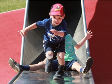 Trent Passmore flies down the Kinsmen Park slide in Saskatoon on Aug. 2, 2016.