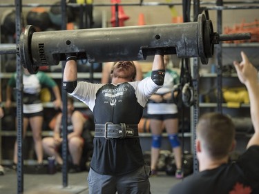 Competitors lift in the log bar event during the Saskatchewan amateur strongman provincial championship at Synergy Strength in Saskatoon, August 6, 2016.