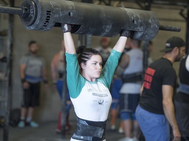 Competitors lift in the log bar event during the Saskatchewan amateur strongman provincial championship at Synergy Strength in Saskatoon, August 6, 2016.