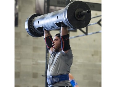 Competitors lift in the log bar event during the Saskatchewan amateur strongman provincial championship at Synergy Strength in Saskatoon, August 6, 2016.