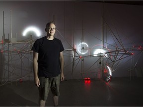 Bruce Montcrombroux poses in front of his art work TL;DR at PAVED Arts on Aug. 22, 2016.  The interactive show uses wood and electronic sensors.