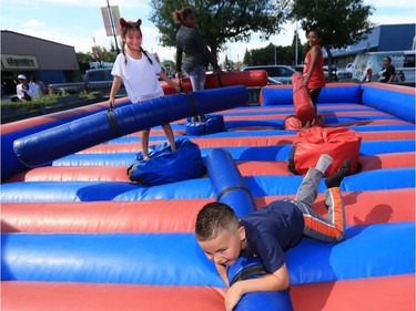 It was a packed house for the annual White Buffalo Youth Lodge Carnival and BBQ, August 25, 2016. One thousand children and youth from Saskatoon's inner city received backpacks after a donation of $25,000 from PotashCorp. Hot dogs, burgers, games and a dunk tank highlighted the outdoor activities. Six-year-old Aubrey Hanson (L) and Zareign Belcourt (front) duke it out with padded logs on one such activity.