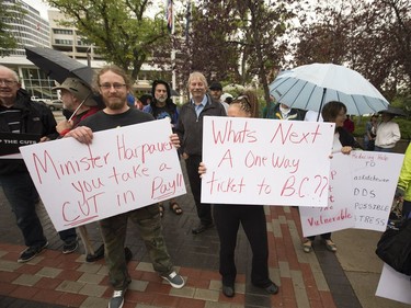 People attend a rally/protest at City Hall and listen to Leader of the Official Opposition Trent Wotherspoon speak about announced Sask. Party cuts to income assistance for the province's most vulnerable, August 26, 2016.