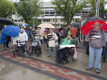 People attend a rally/protest at City Hall and listen to Leader of the Official Opposition Trent Wotherspoon speak about announced Sask. Party cuts to income assistance for the province's most vulnerable, August 26, 2016.