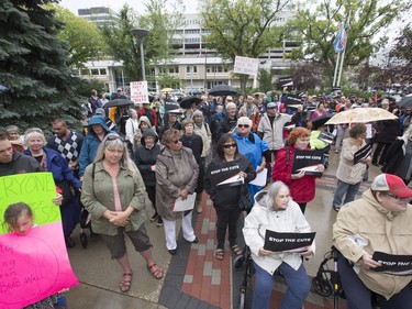 People attend a rally/protest at City Hall and listen to Leader of the Official Opposition Trent Wotherspoon speak about announced Sask. Party cuts to income assistance for the province's most vulnerable, August 26, 2016.