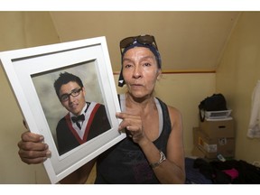 Wilma Merasty holds a photo of her son David, who was killed in June. His killer is still out there.