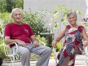 Sylvie Francoeur, right, and her husband Cliff Shockey sit in the garden area of Wolf Willow, which is an apartment-style building in Saskatoon.