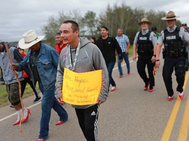 Several police officers and other men wore red high heels during the annual Walk for Missing and Murdered Indigenous women at Ahtahkakoop First Nation on Aug. 23, 2016.