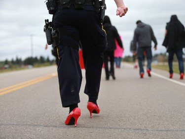 Several police officers and other men wore red high heels during the annual Walk for Missing and Murdered Indigenous women at Ahtahkakoop First Nation on Aug. 23, 2016.