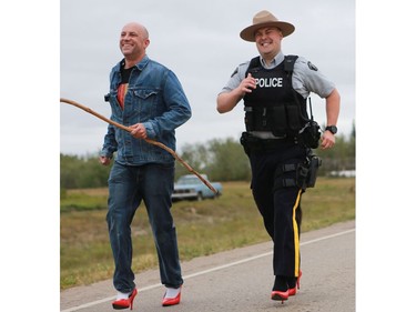 Several police officers and other men wore red high heels during the annual Walk for Missing and Murdered Indigenous women at Ahtahkakoop First Nation on Aug. 23, 2016.