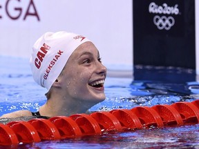 Canada's Penny Oleksiak reacts after she won the Women's 100m Freestyle Final during the swimming event at the Rio 2016 Olympic Games at the Olympic Aquatics Stadium in Rio de Janeiro on August 11, 2016.