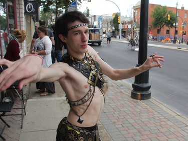 Twenty-one-year-old Jace Adamson, executes a complicated belly-dancing move outside of the Broadway Café before a belly-dancing performance by the Oriental Dance Arts of Saskatoon as part of the PotashCorp Fringe Festival on Thursday evening, August 4, 2016. He hopes to inspire other men to take up the dance form, which he said is both complex and relaxing at the same time. (Morgan Modjeski/The Saskatoon StarPhoenix)