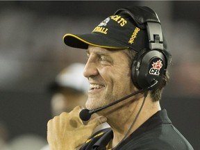 Hamilton Tiger-Cats head coach Kent Austin smiles after a play in the second half of CFL football action against the B.C. Lions in Hamilton on Saturday, August 15, 2015. The Tiger-Cats defeated the Lions 52-22.