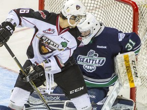 Vancouver Giants Thomas Foster, left is stopped by Seattle Thunderbirds goalie Logan Flodell, right during the first period of a WHL regular-season game at the Pacific Coliseum in Vancouver, B.C. Monday February 9, 2015.