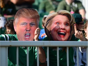 Fans wear Donald Trump and Hillary Clinton masks during Sunday's CFL game between the Saskatchewan Roughriders and the visiting Edmonton Eskimos.