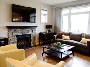 Homes by Dream's Stonebridge parade home offers a spacious, open feel, enhanced by nine-foot ceilings and oversized windows. Arched doorways on either side of the living room and kitchen help define those spaces. (Photo: Jeannie Armstrong)