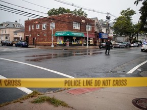 A local police officer stands guard at an intersection as members of the Federal Bureau of Investigation (FBI) and other law enforcement officials investigate a residence in connection to Saturday night's bombing in Manhattan on September 19, 2016 in Elizabeth, New Jersey.