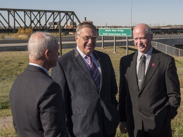 Mark Howe, left, and Marty Howe, right, sons of Gordie Howe speak with mayoral candidate of Saskatoon Don Atchison near the newly-named Gordie Howe Bridge in Saskatoon, Sunday, September 25, 2016.