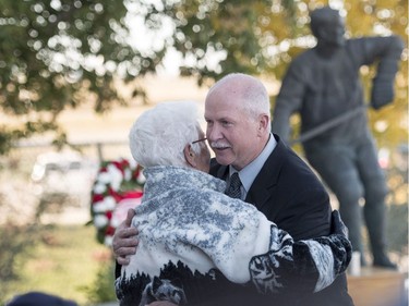 Marty Howe, son of Mr. Hockey Gordie Howe, right, hugs his aunt Helen Howe prior to the internment of Gordie Howe's remains at the base of a statue of him during a memorial service outside Sasktel Centre in Saskatoon, Sunday, September 25, 2016.