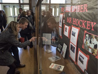 Members of Gordie Howe's family look over a display highlighting Gordie Howe at King George School, the elementary school Howe attended, in Saskatoon, Sunday, September 25, 2016.