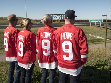 Members of Gordie Howe's family, wearing his jersey, stand for a photograph near the newly named Gordie Howe Bridge in Saskatoon, September 25, 2016.