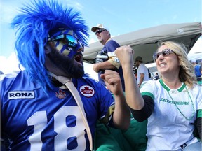 Saskatchewan Roughriders fan Christine Gray (right) and Winnipeg Blue Bomber fan Ryan Krause are at odds while tailgating prior to the Banjo Bowl in Winnipeg on Sat., Sept. 10, 2016.