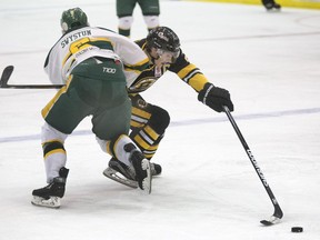 Humboldt Broncos defenceman Connor Swystun (6) tries holding off the rushing Estevan Bruins captain Lynnden Pastachak (27), September 26, 2016. (GordWaldner/Saskatoon StarPhoenix)