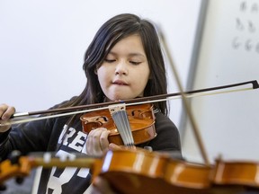 St. Michaels School band member Dalyce O'Soup learns to play the fiddle in the school's new program