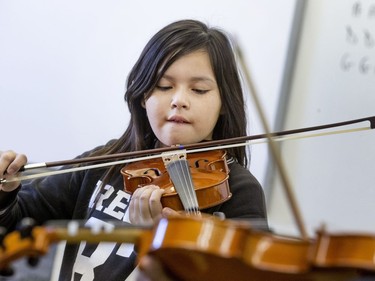 St. Michael Community School student Dalyce O'Soup is among the students eager to learn to play the fiddle in the school's new program that was gifted with 25 new instruments by master fiddler Natalie MacMaster, September 27, 2016.