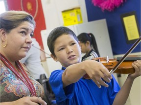 St. Michael Community School band teacher Cristin Dorgan Lee and students like Damien James-Caron who are eager to learn to play the fiddle in the school's new program that was blessed with the gift of 25 new fiddles from master fiddler Natalie MacMaster, September 27, 2016.