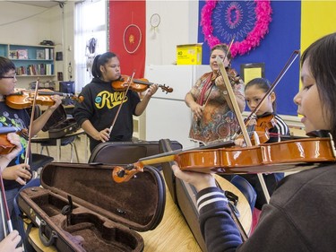 St. Michael Community School band teacher Cristin Dorgan Lee with students who are eager to learn to play the fiddle in the school's new program that was gifted with 25 new instruments by master fiddler Natalie MacMaster, September 27, 2016.