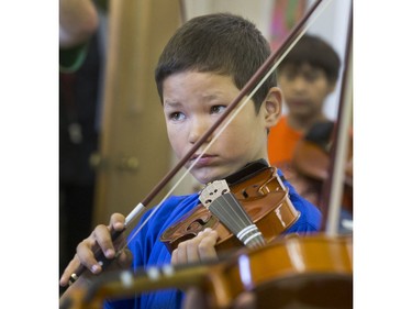 St. Michael Community School student Damien James-Caron is among the students eager to learn to play the fiddle in the school's new program that was gifted with 25 new instruments by master fiddler Natalie MacMaster, September 27, 2016.