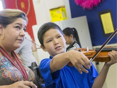 St. Michael Community School band teacher Cristin Dorgan Lee with Damien James-Caron, who is eager to learn to play the fiddle in the school's new program that was gifted with 25 new instruments by master fiddler Natalie MacMaster, September 27, 2016.