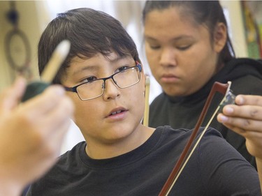 St. Michael Community School students like Zack Sanderson are eager to learn to play the fiddle in the school's new program that was gifted with 25 new instruments by master fiddler Natalie MacMaster, September 27, 2016.