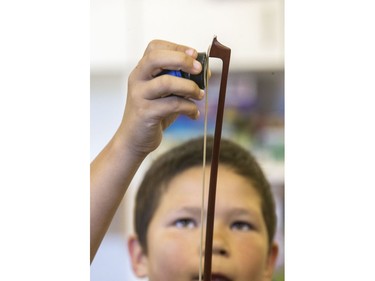 St. Michael Community School student Damien James-Caron is among students eager to learn to play the fiddle in the school's new program that was gifted with 25 new instruments by master fiddler Natalie MacMaster, September 27, 2016.