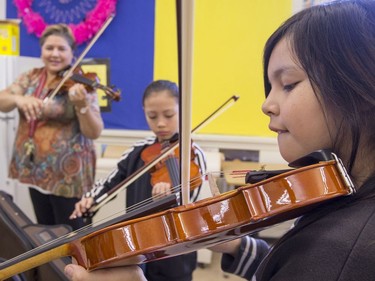 L-R: St. Michael Community School band teacher Cristin Dorgan Lee with students Lexus Bayani and Dalyce O'Soup, who are eager to learn to play the fiddle in the school's new program that was gifted with 25 new instruments by master fiddler Natalie MacMaster, September 27, 2016.