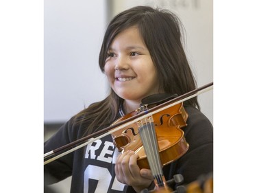 St. Michael Community School students are eager to learn to play the fiddle in the school's new program that was gifted with 25 new instruments by master fiddler Natalie MacMaster, September 27, 2016.