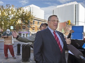 Homeless protesters interrupt Saskatoon mayoral candidate Don Atchison during a downtown news conference on Thursday.