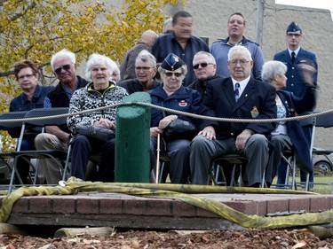 Members of the RCAF, including Evelyn Campbell in front centre, at 2407 Ave. C N. wait patiently while the lid of a time capsule is dragged off the vault, September 29, 2016. The vault was placed  across the street from the RCAF home.