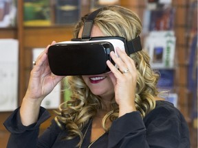 Candace Schierling, Director of National Conventions and Events Marketing with Tourism Saskatoon tests out a pair of virtual reality goggles. September 8, 2016.