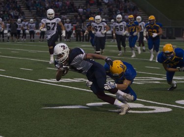 A player from the Regina Thunder carries the ball past the Saskatoon Hilltops during play at SMF field in Saskatoon, September 10, 2016.