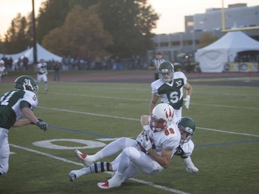 Calgary Dinos #89 Whitman Tomusiak gets tackled by the U of S Huskies during the home opener at Griffiths Stadium in Saskatoon, September 16, 2016.