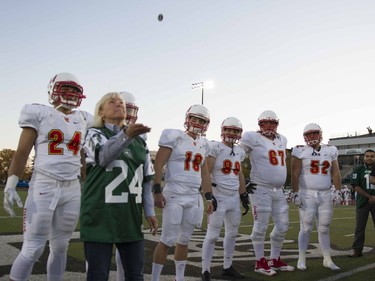 The Calgary Dinos watch the opening coin toss during the U of S Huskies home opener at Griffiths Stadium in Saskatoon, September 16, 2016.