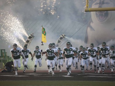 The U of S Huskies rush the field during the opening ceremonies before playing the Calgary Dinos at Griffiths Stadium in Saskatoon, September 16, 2016.