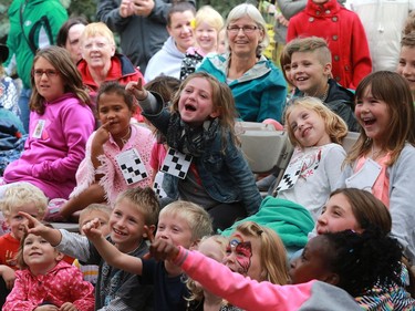 Children yell and point out the wolf puppet during a Wide Open puppet show at the Word on the Street festival in Saskatoon on September 18, 2016.