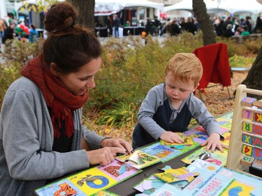 Guylaine Deschambault and Malcolm Wilson work on an alphabet puzzle at the Word on the Street festival in Saskatoon on September 18, 2016 .