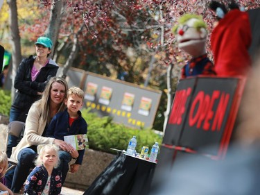 Rachelle and Braxton Boschman watch a Wide Open puppet show during the Word on the Street festival in Saskatoon on September 18, 2016 .
