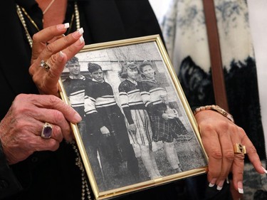 Gordie Howe's daughter Cathy Howe and his sisters hold up a childhood photo of him in King George school, where he attended school as a child in Saskatoon on September 25, 2016.