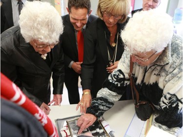 Gordie Howe's family members look at a photo of Gordie Howe as a child in King George school, where he attended school in Saskatoon on September 25, 2016.